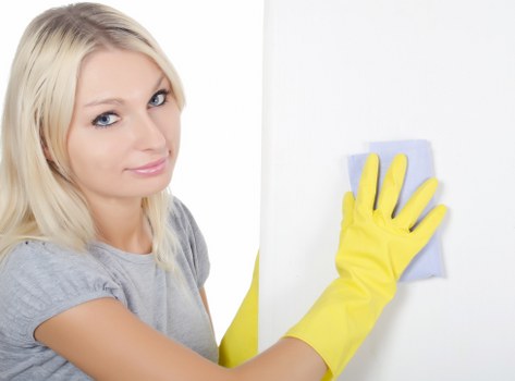 Technician cleaning a built-in oven door glass in a Wandsworth property